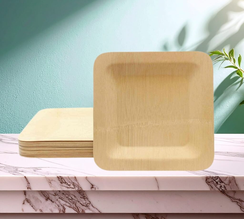 Disposable square bamboo plates for kids party table settings, pack shown stacked on marble surface.