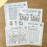 OneStopBox set of party-themed activity sheets including a word search, spot the difference, present maze, and coloring sheet on a wooden surface.
