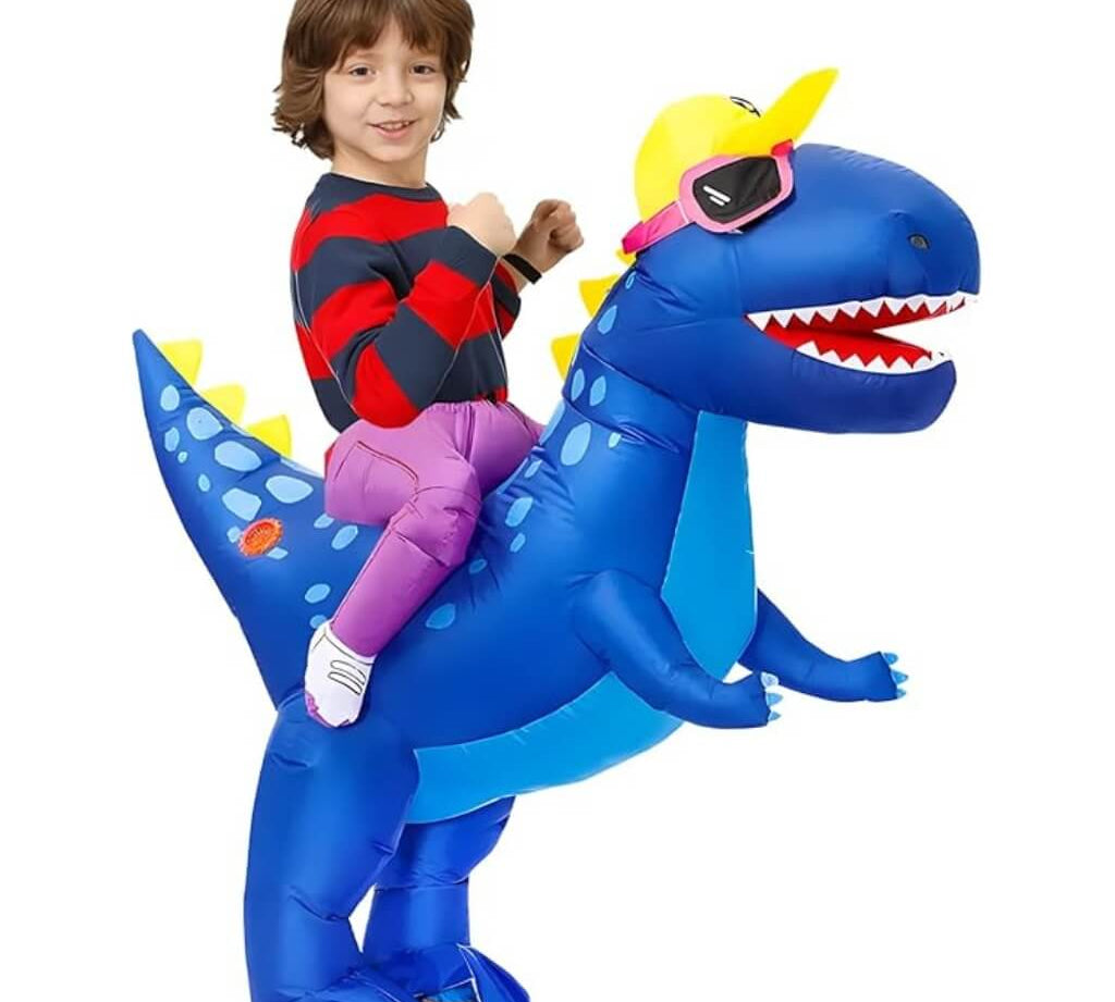 Child sitting on an inflatable blue dinosaur costume with a white background