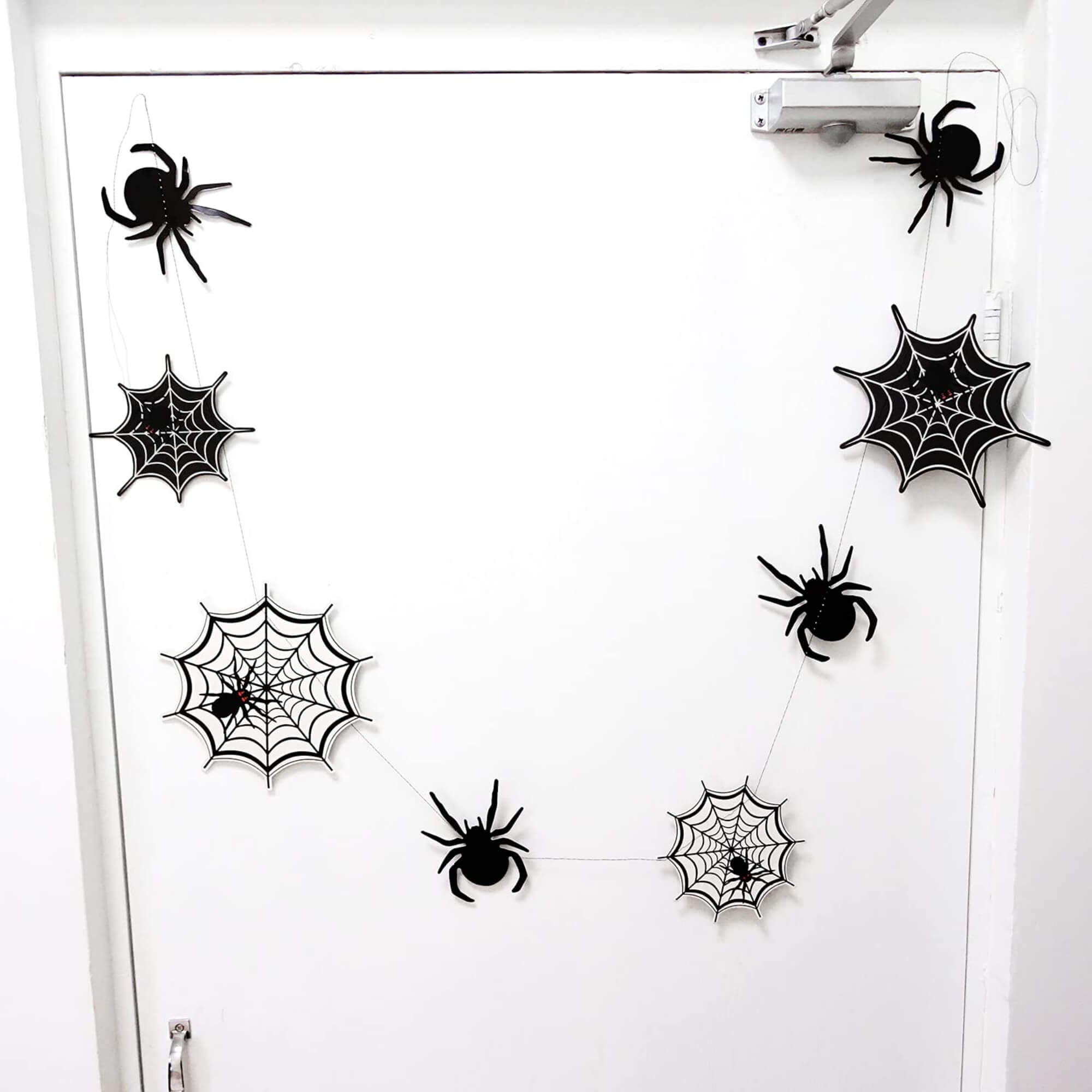 Spider web Halloween hanging banner decoration, on a front door