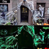 Glow-in-the-dark Halloween spider web cobweb decoration, daytime shot, lit at night