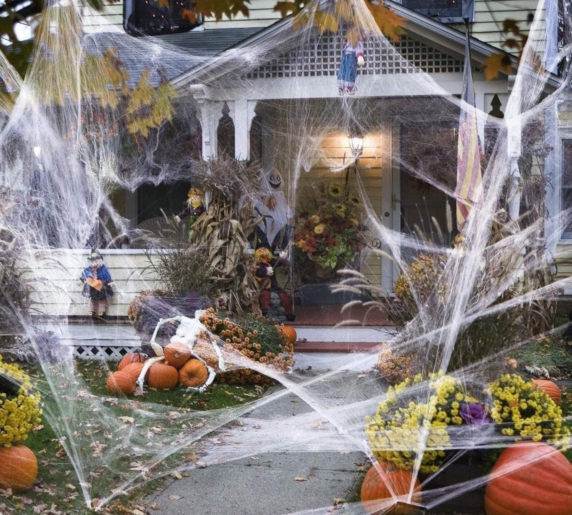 Glow-in-the-dark Halloween spider web cobweb decoration, on a house