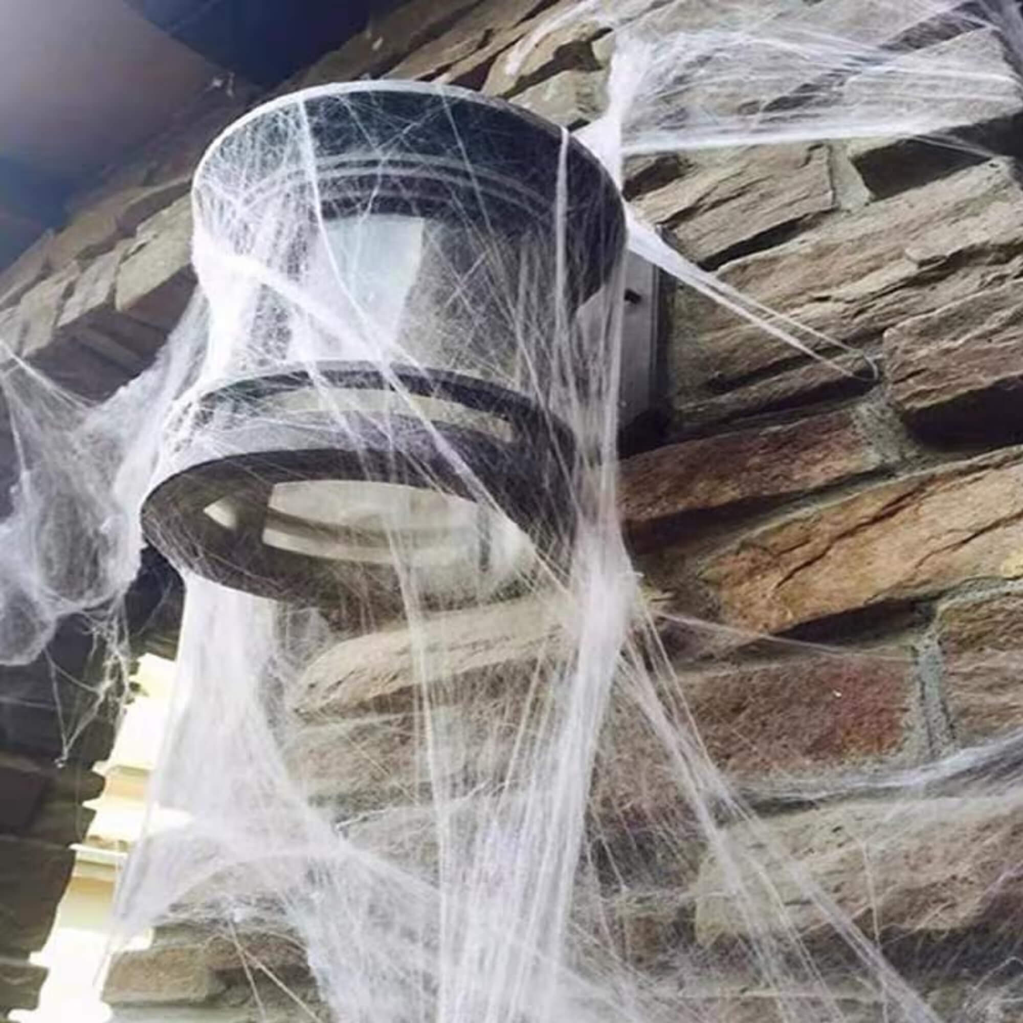 Glow-in-the-dark Halloween spider web cobweb decoration, lit up