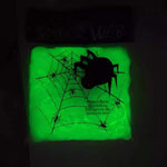Glow-in-the-dark Halloween spider web cobweb decoration, lit at night