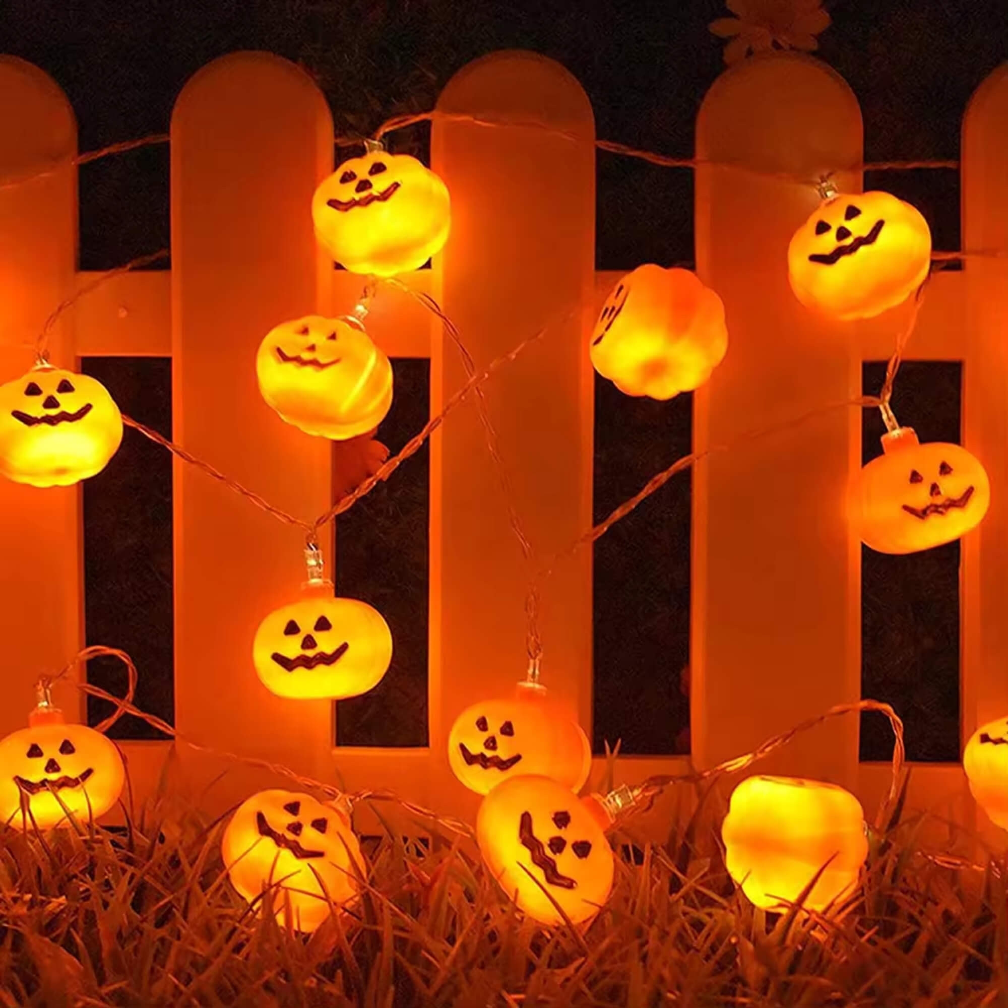 Pumpkin LED fairy lights Halloween decoration, hung on a fence