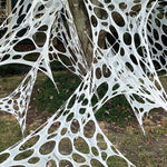 Outdoor stretch spider web Halloween decoration, hung on a tree