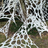 Outdoor stretch spider web Halloween decoration, hung on a tree