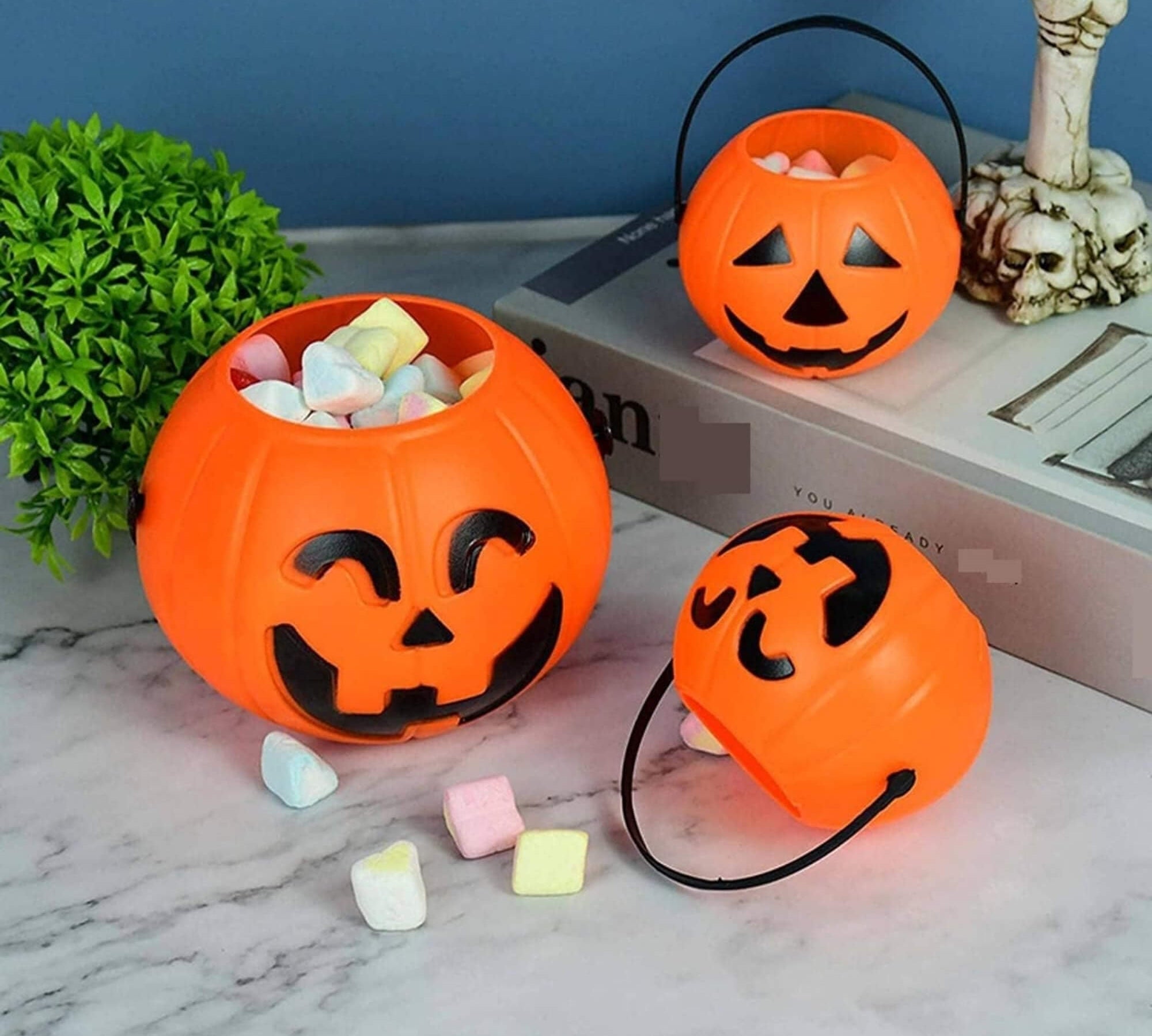 Jack-o'-lantern pumpkin trick-or-treat bucket Halloween decoration, filled with marshmallows