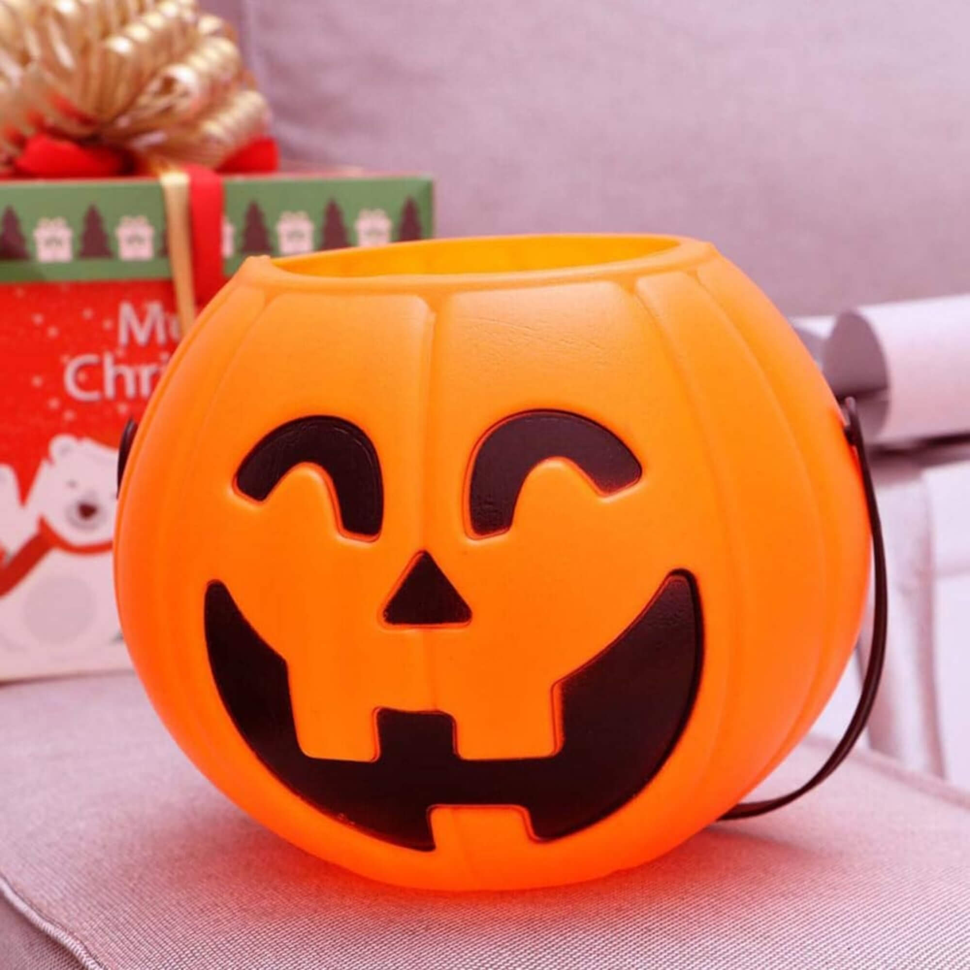 Jack-o'-lantern pumpkin trick-or-treat bucket Halloween decoration, styled scene