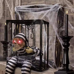 Animatronic skeleton in hanging cage Halloween decoration, with cobweb prop