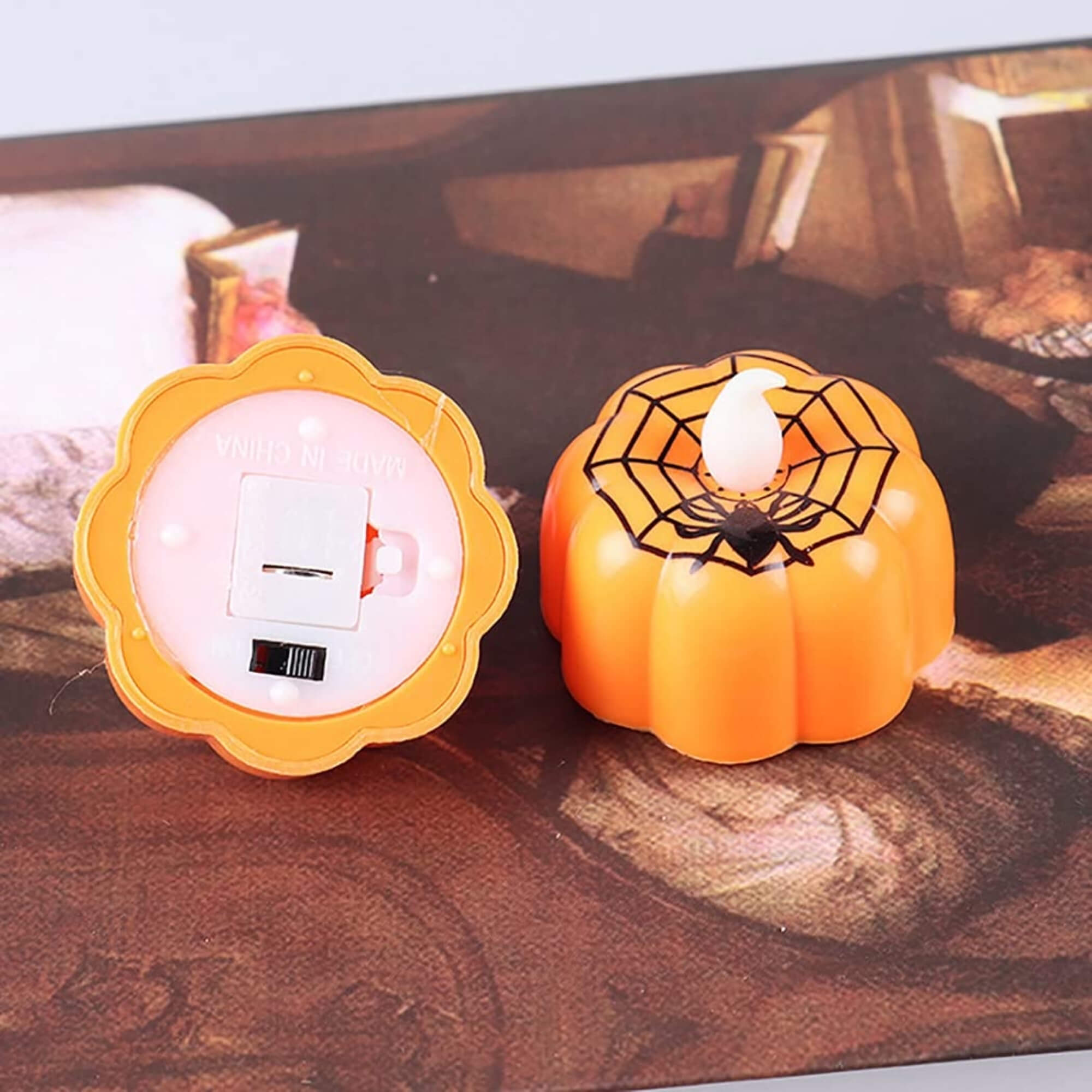 Small orange pumpkin LED tealight candle Halloween decoration, base view