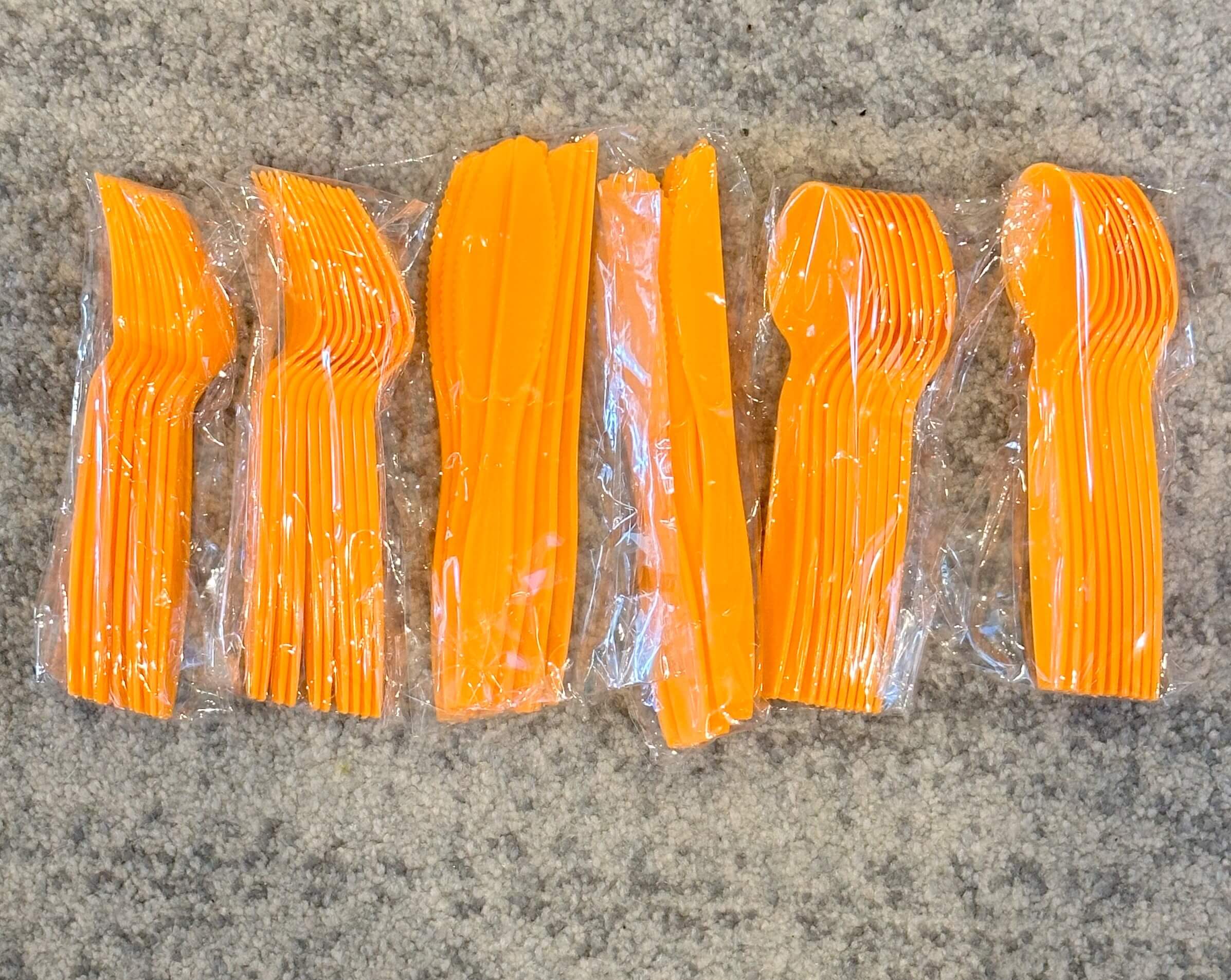 Reusable orange Halloween cutlery with spoons, forks, and knives