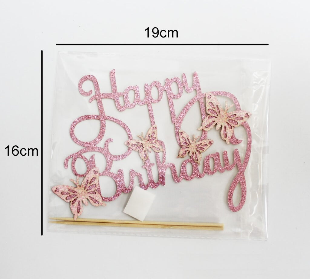 Pink 'Happy Birthday' cake topper with butterfly designs in a clear package, showing dimensions.