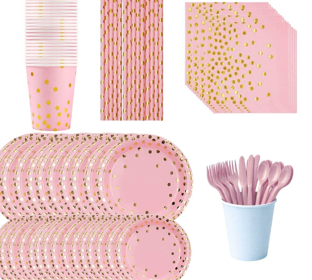 Pink and gold party supplies including plates, cups, straws, and cutlery.