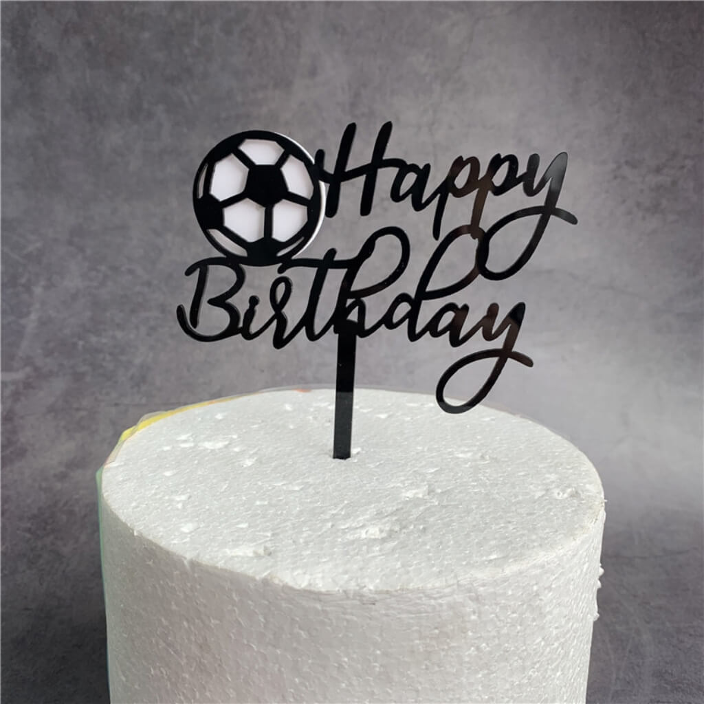 Sports-themed cake topper with ball design