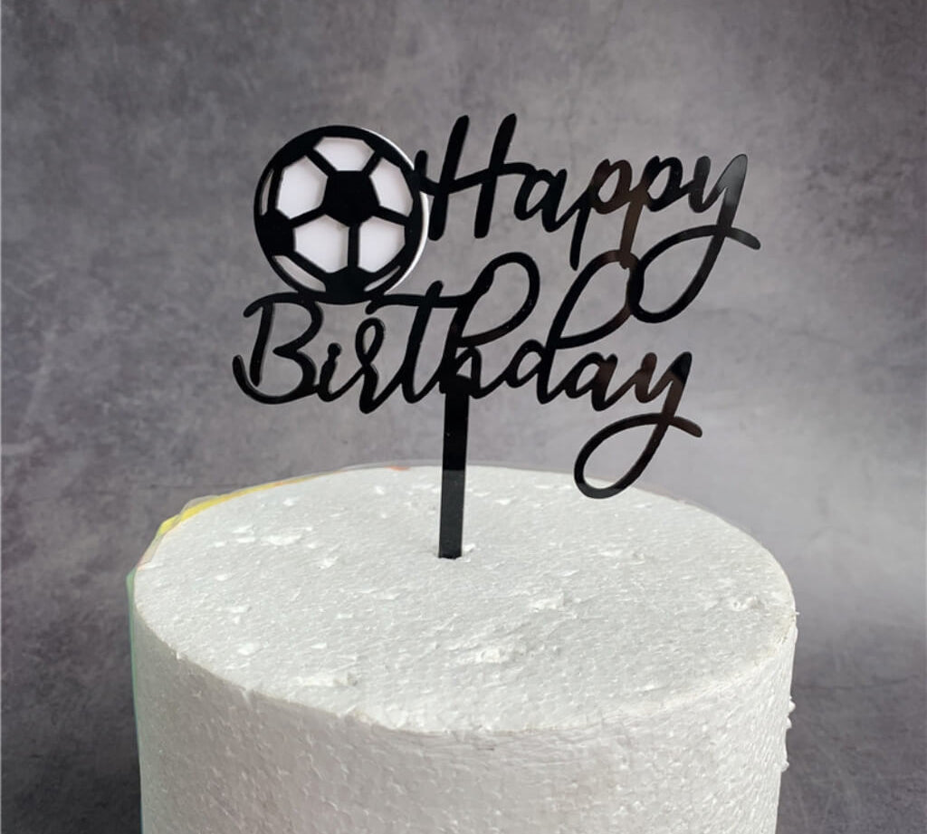 Sports-themed cake topper with ball design