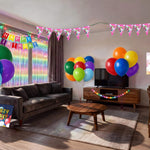 Unicorn rainbow kids birthday party decorations set up in living room, with balloons, banner, fringe curtain and tablecloth, Australia